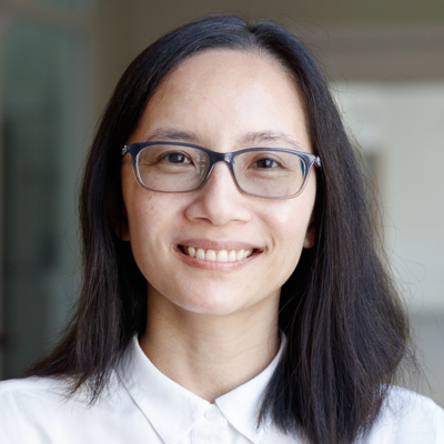 http://Headshot%20of%20Khanh%20Vo%20smiling%20in%20white%20button%20down%20with%20glasses.